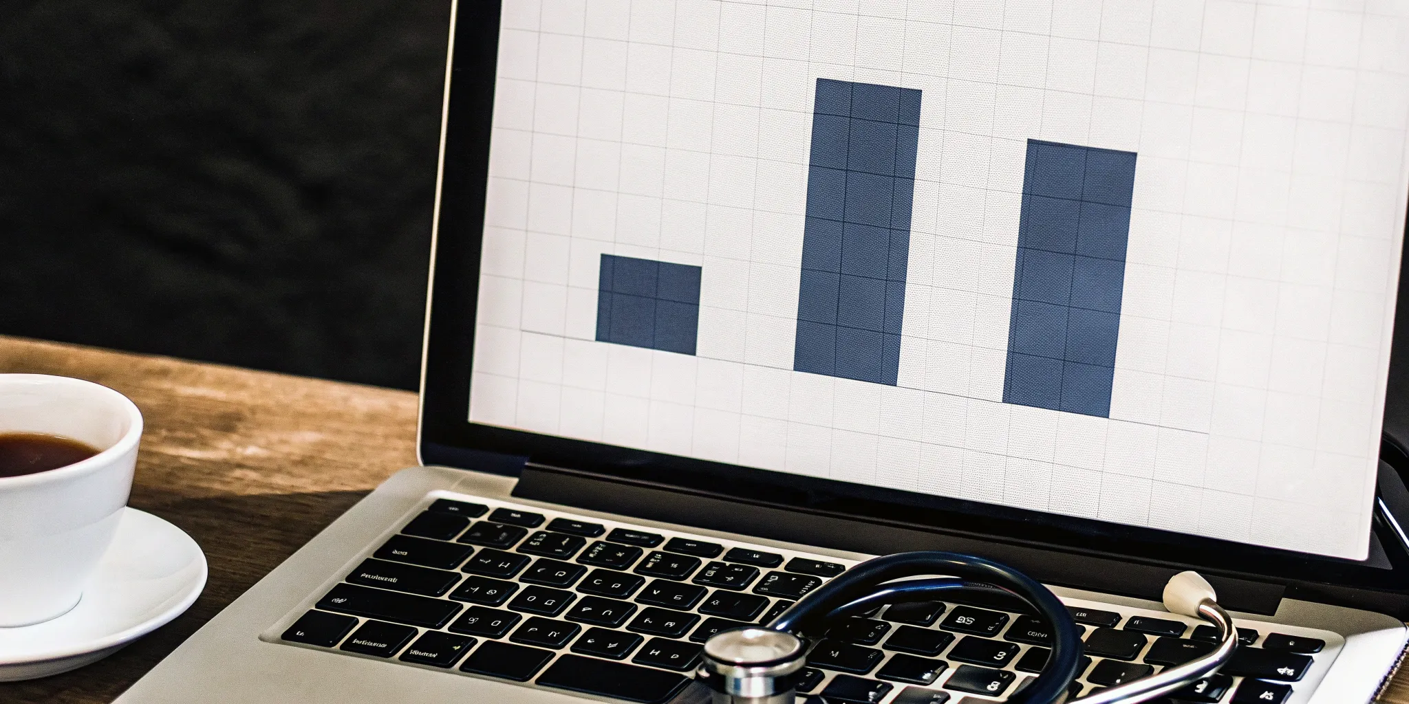 A laptop on a desk displaying a bar graph analysis of the COBRA administration fee.