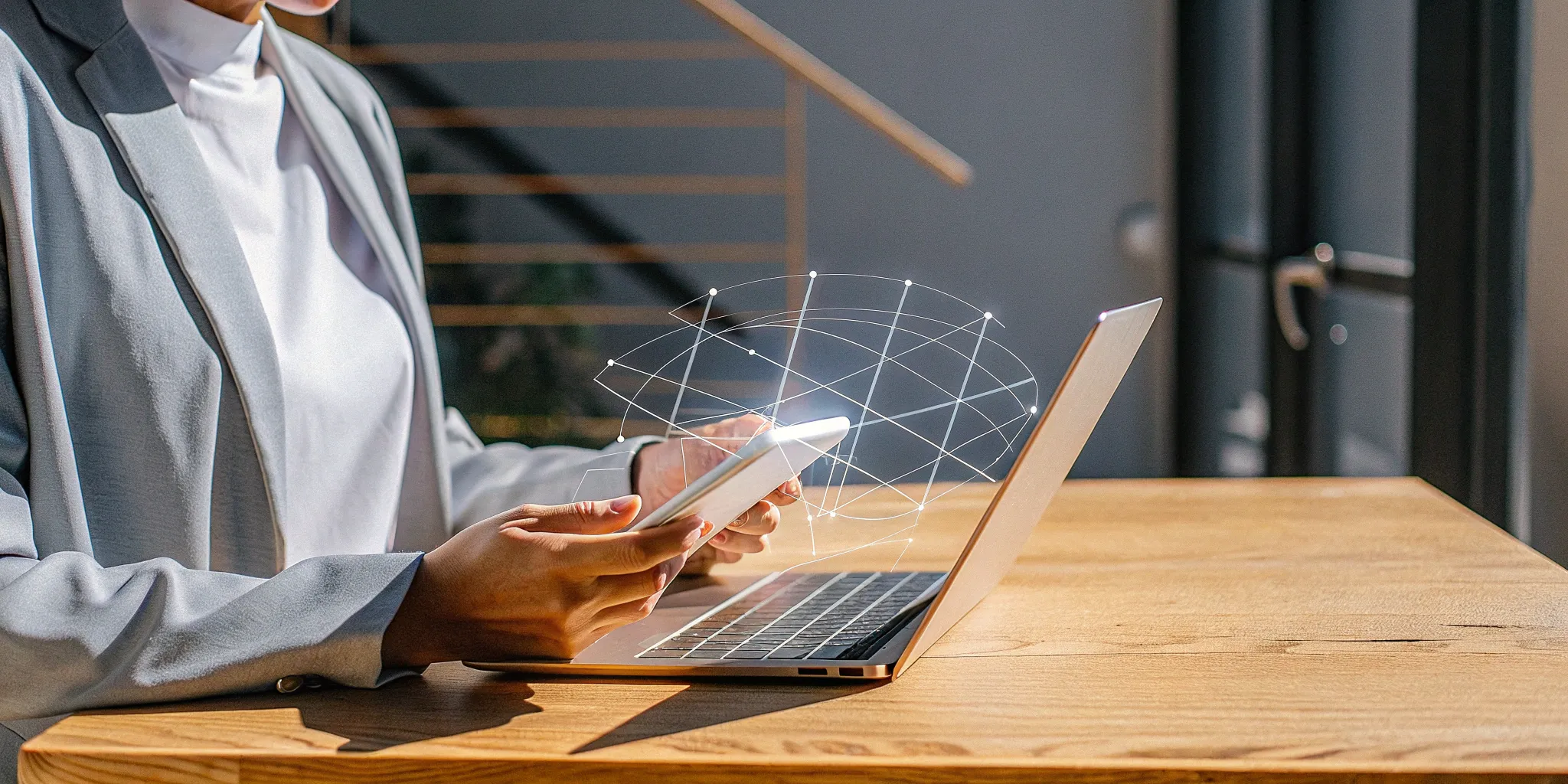 A small business owner at a desk researching group health insurance plans on a laptop.