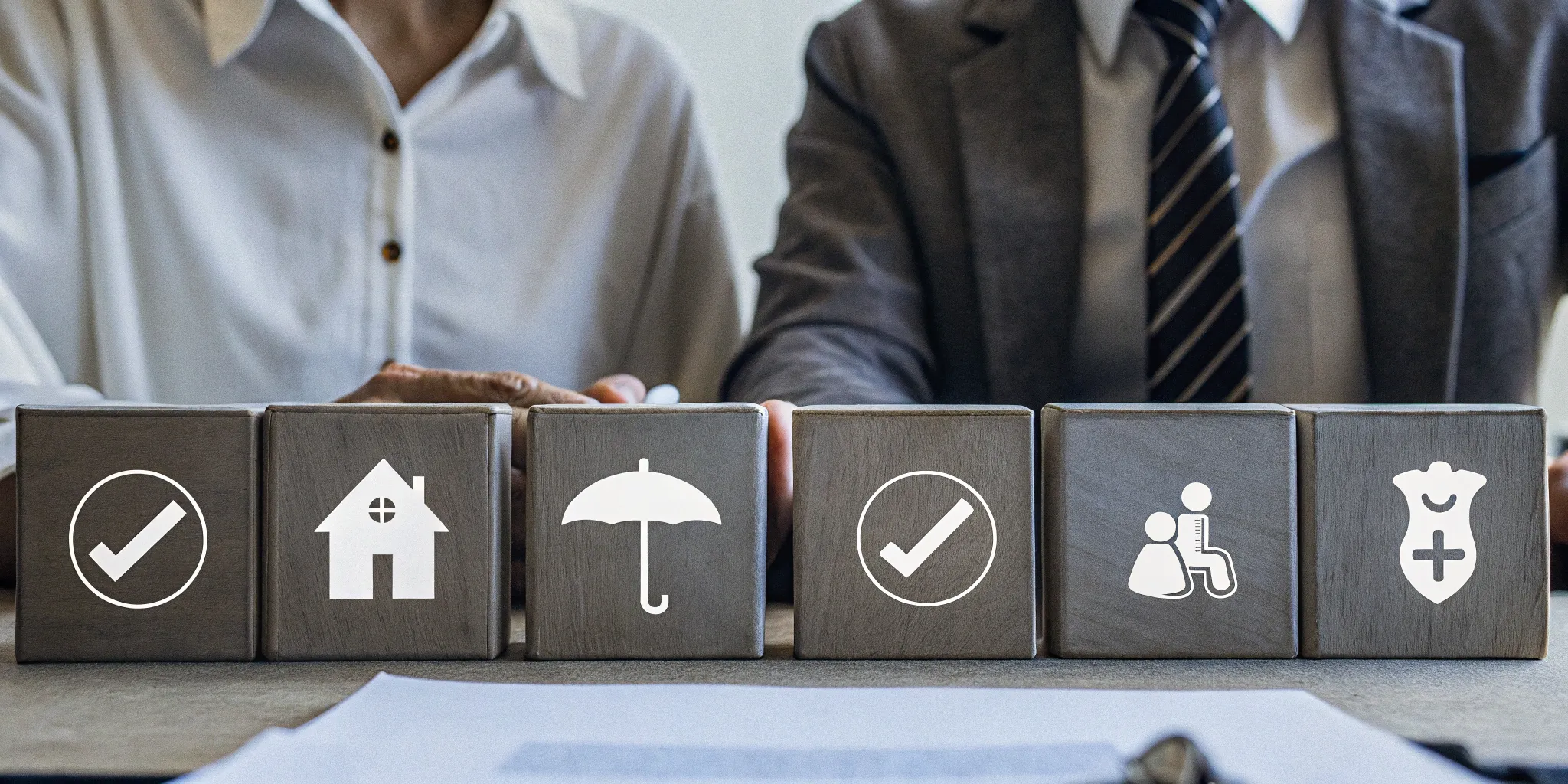 An employer's health insurance plan options shown as icons on wooden blocks.