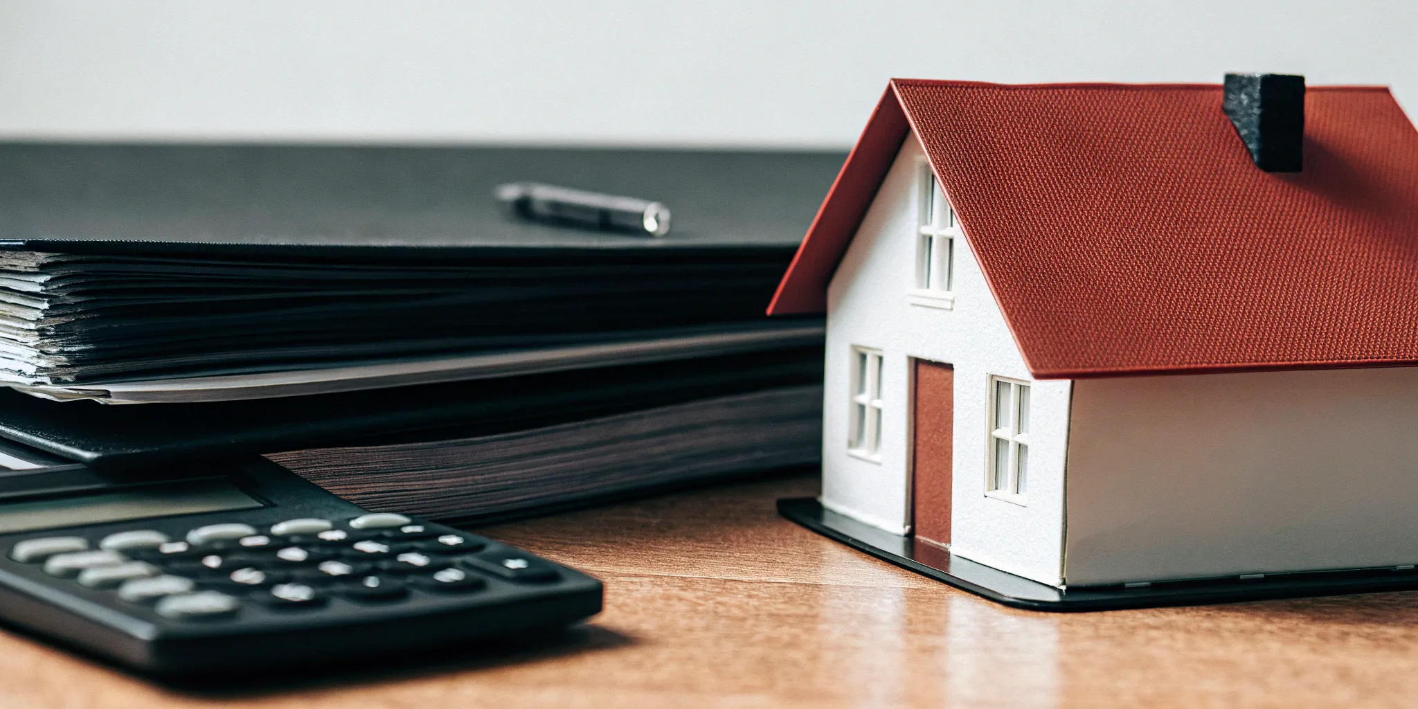 An employer uses a calculator to review documents for a short term disability insurance plan.