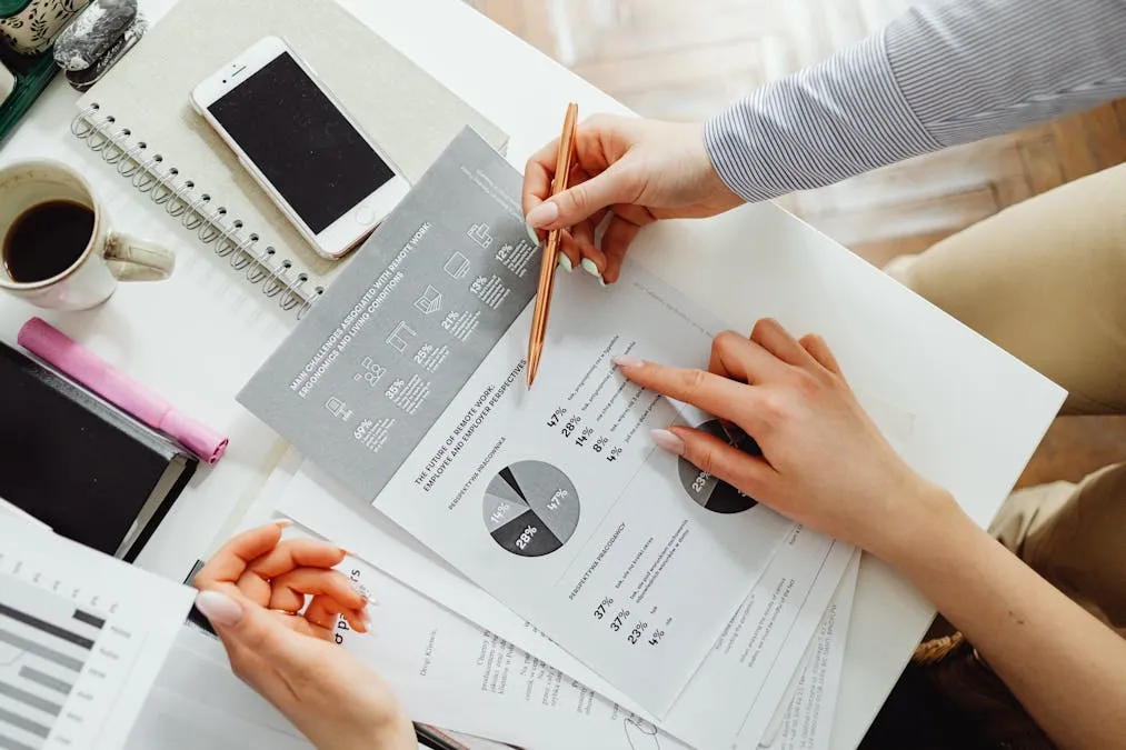 HR professionals reviewing employee benefits benchmarking data and comparison charts at a conference table